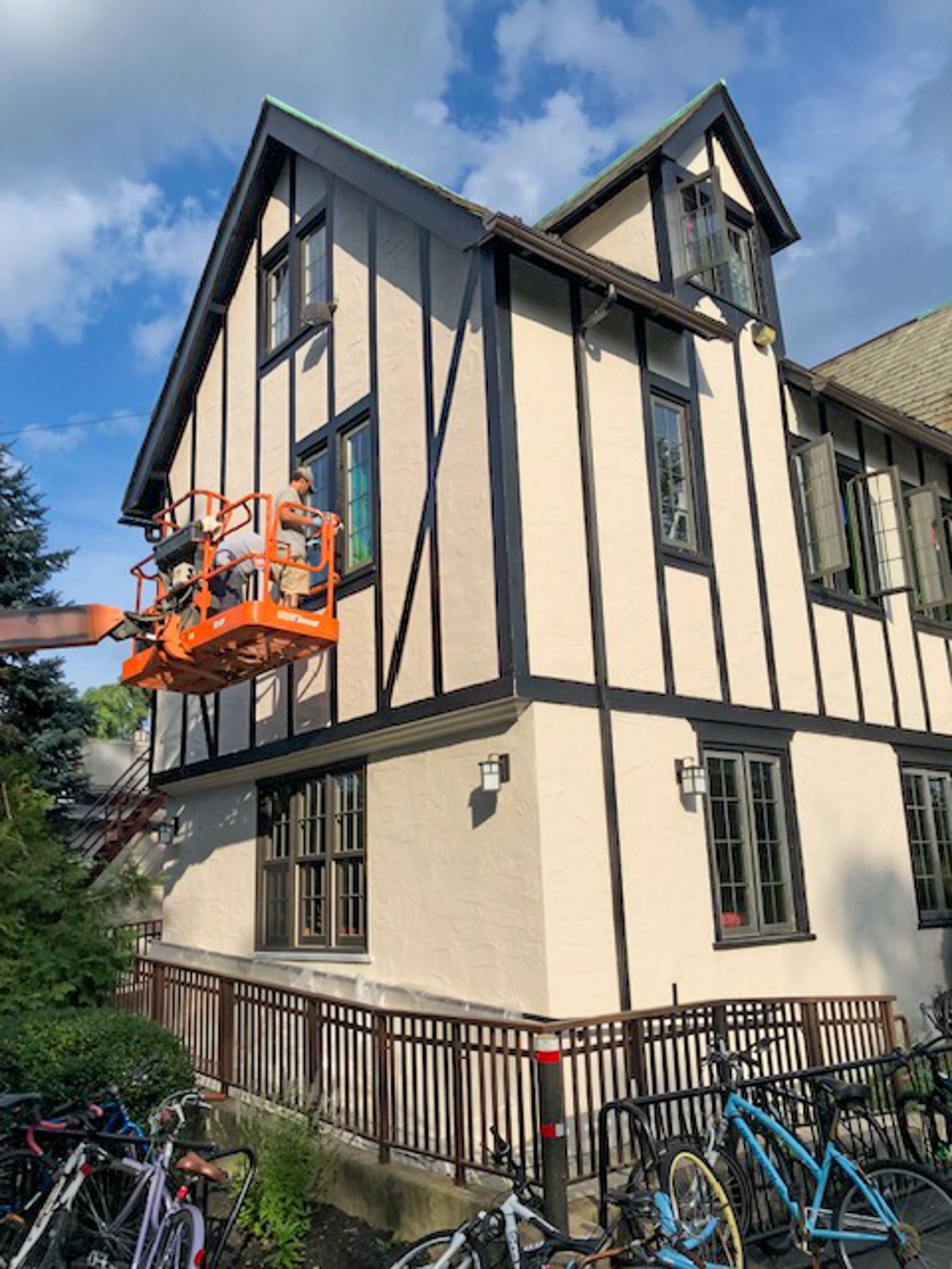 A group of people are working on the side of a building.