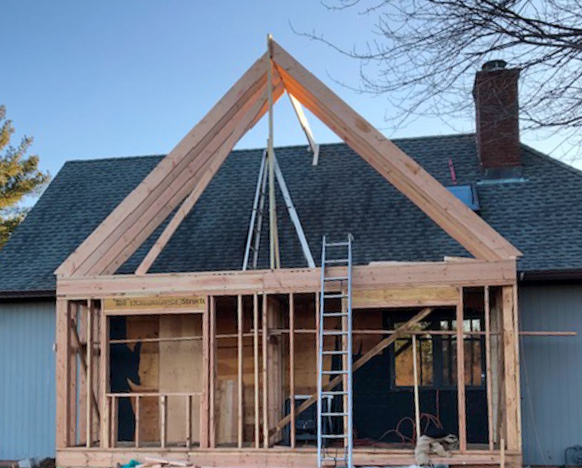 A house that is being built with a ladder in front of it