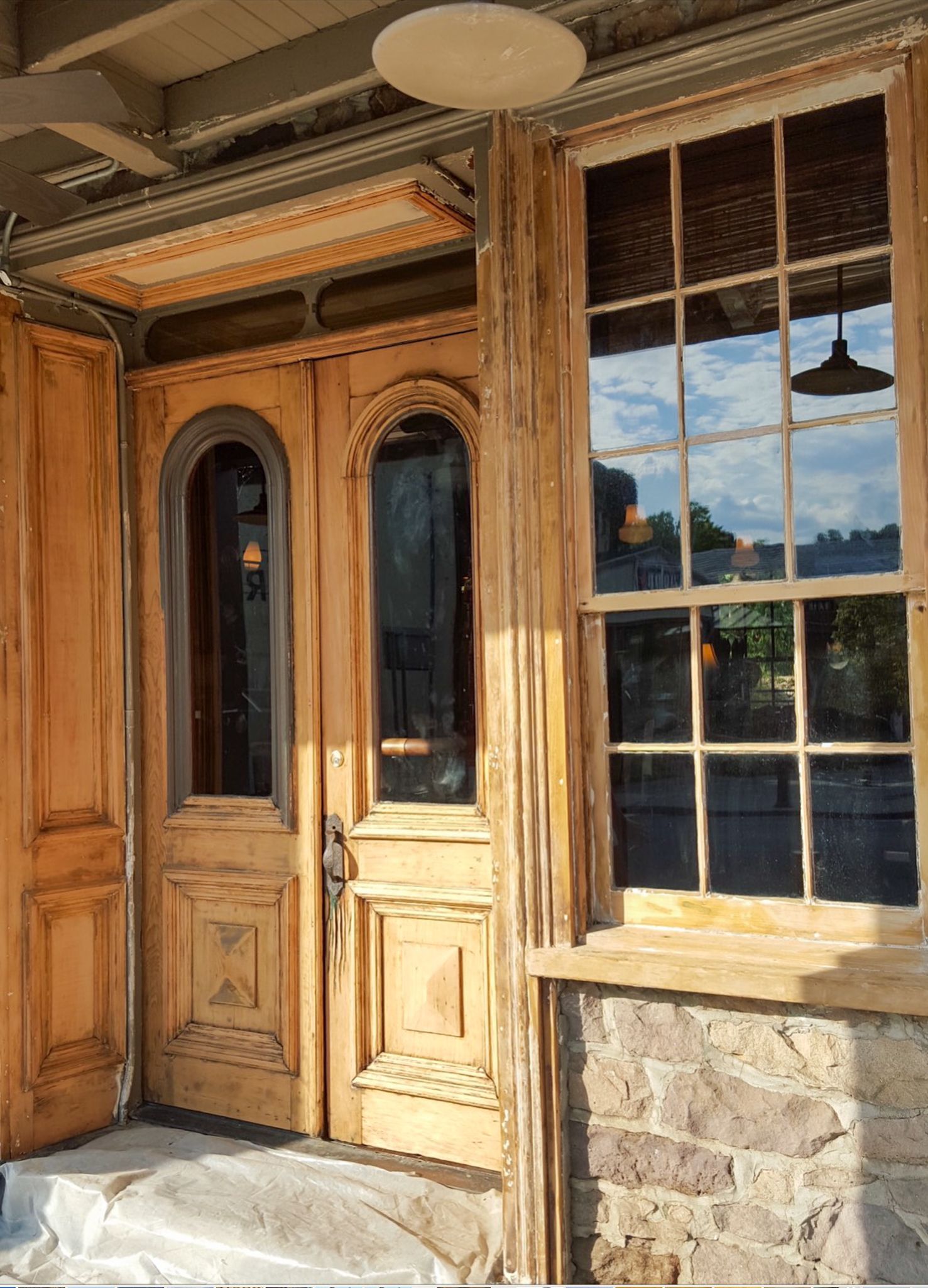 A wooden door with a window on the side of a building