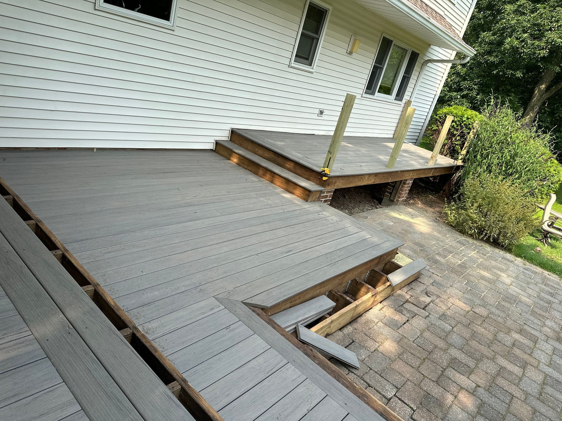 A wooden deck is being built on the side of a house.