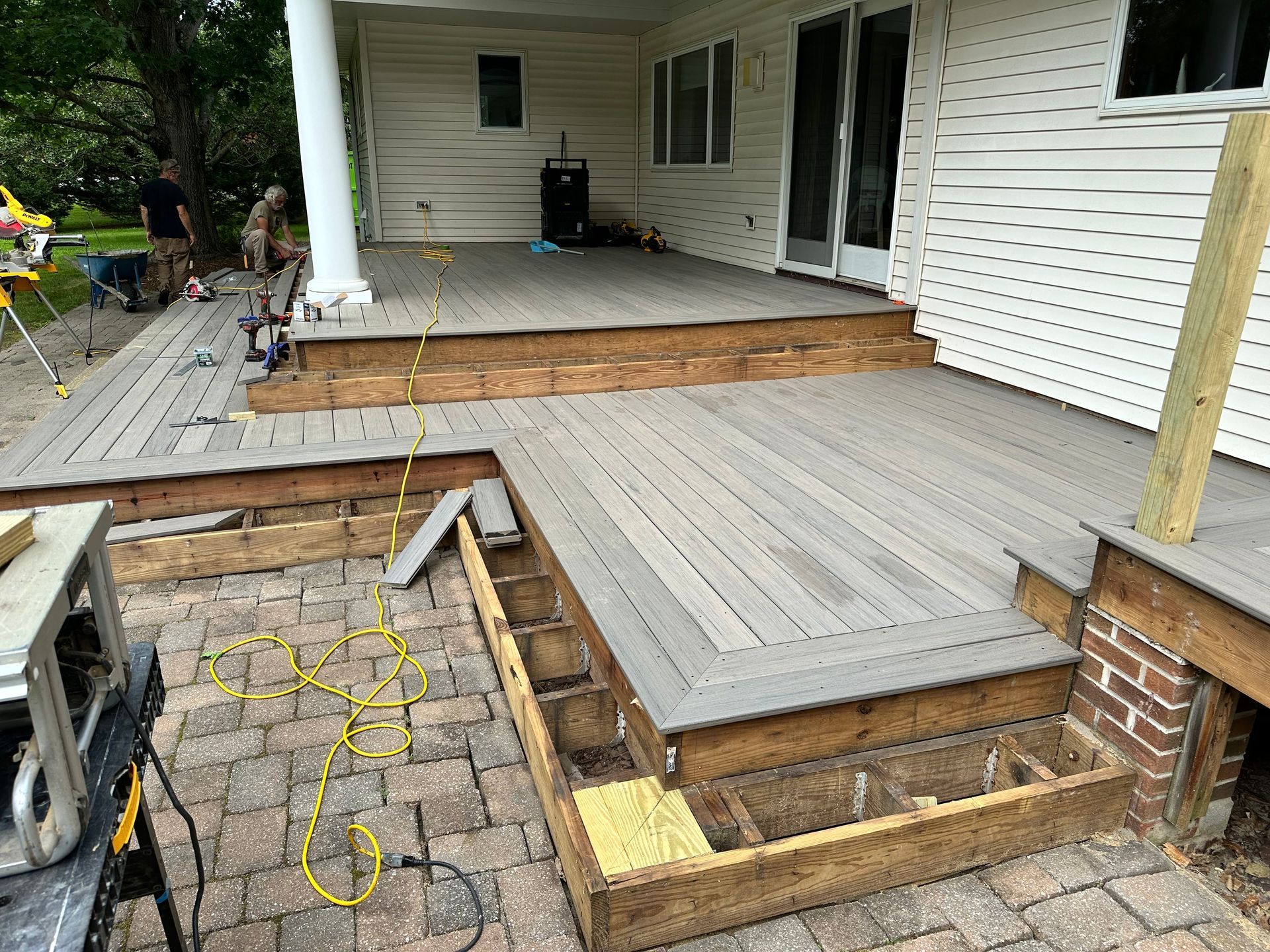 A wooden deck is being built on the side of a house.