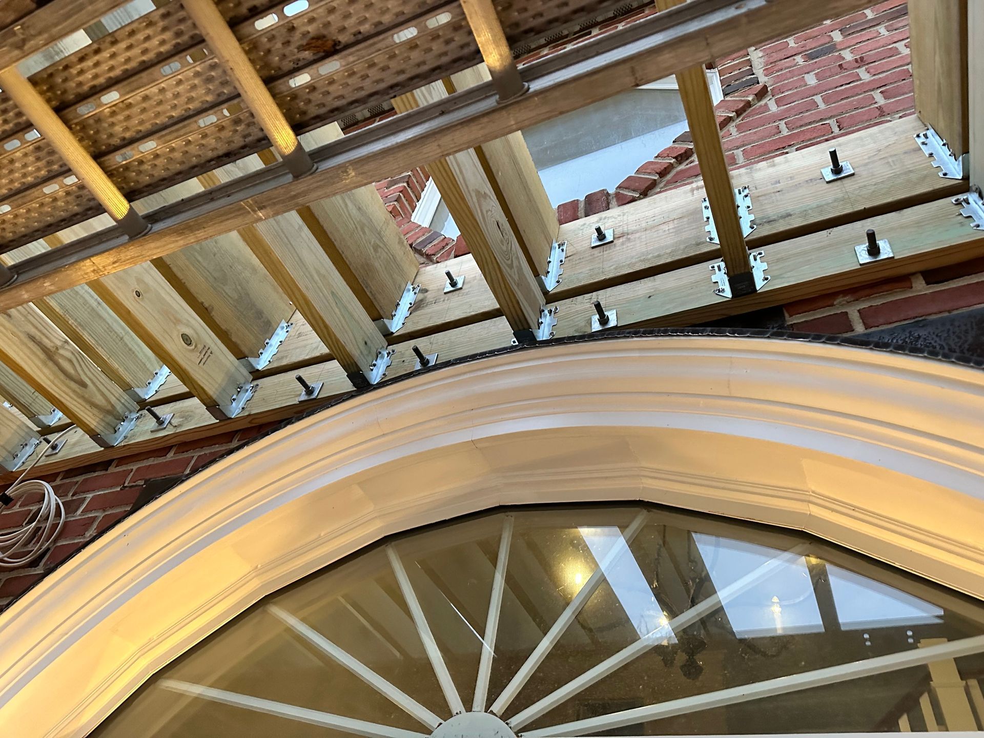 A building under construction with a window in the middle of it.