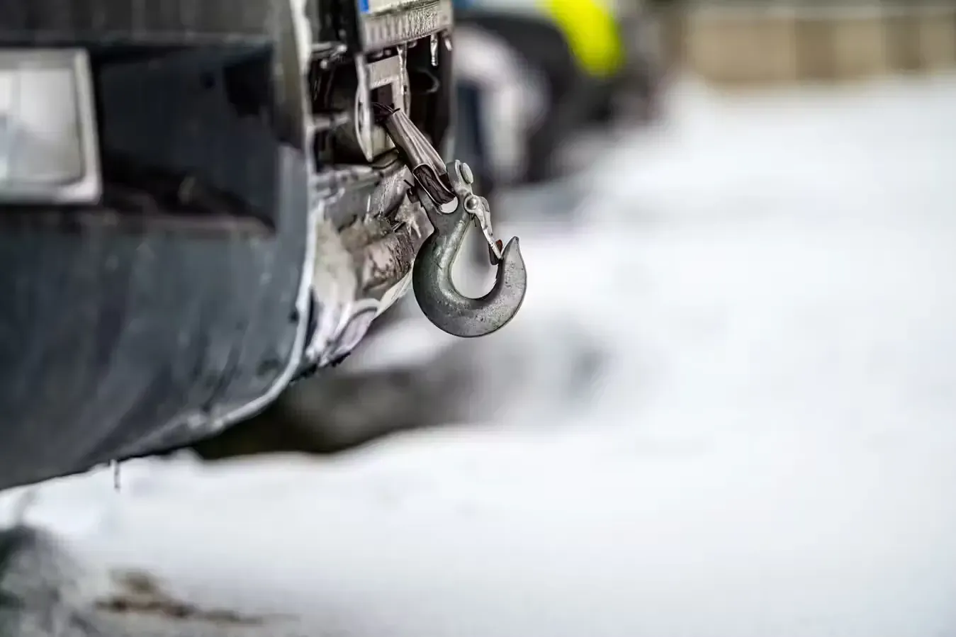 A close up of a tow hook on the front of a car. A close up of a tow hook on the front of a car.