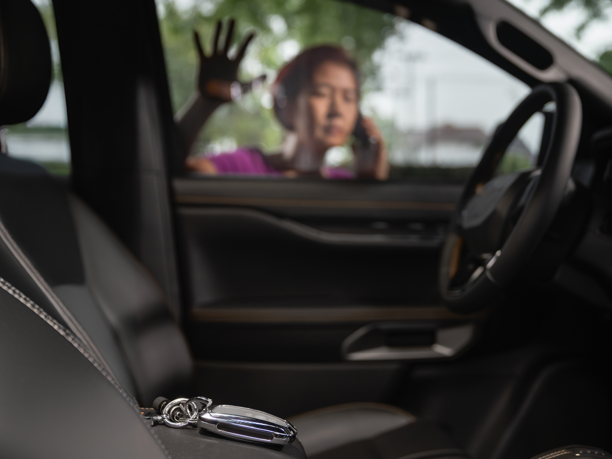 A woman is sitting in a car talking on a cell phone A woman is sitting in a car talking on a cell phone