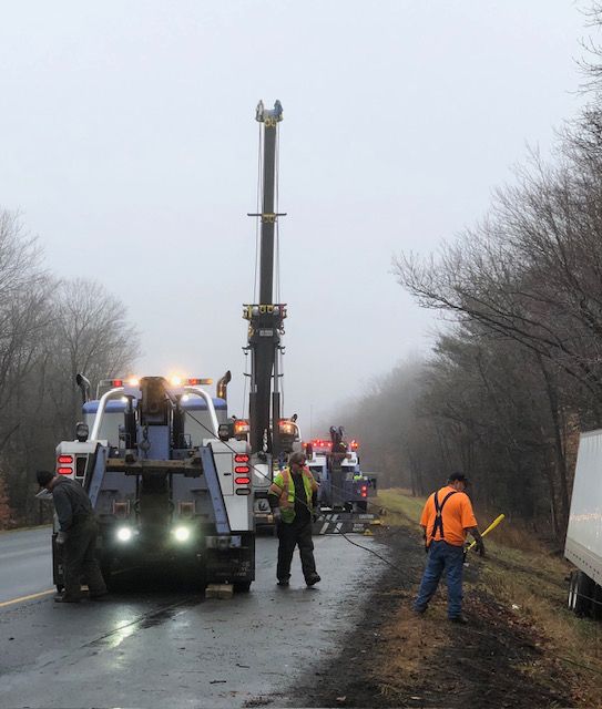 A tow truck is on the side of the road