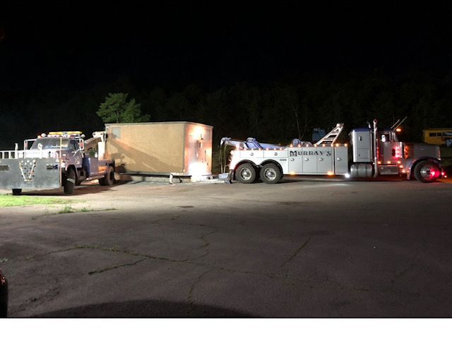 tow truck at night in parking lot towing