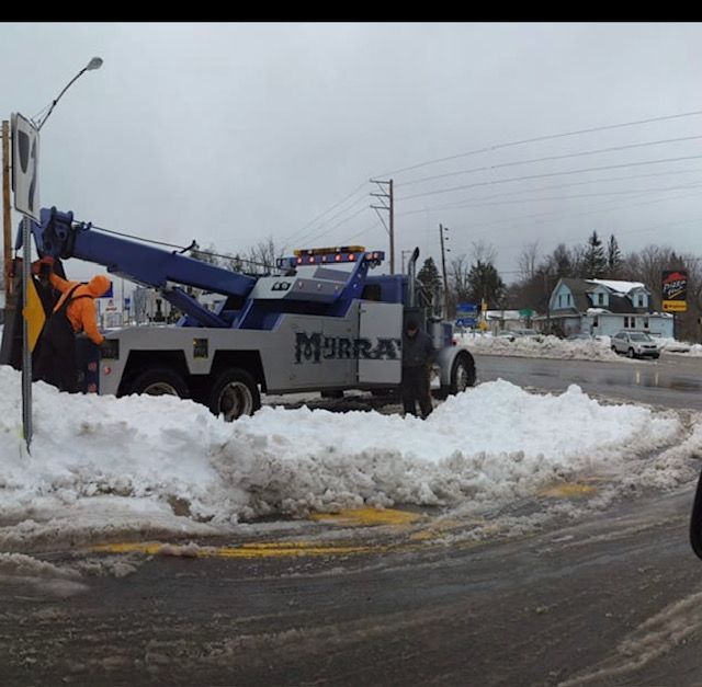 tow truck  on road in snow and slush