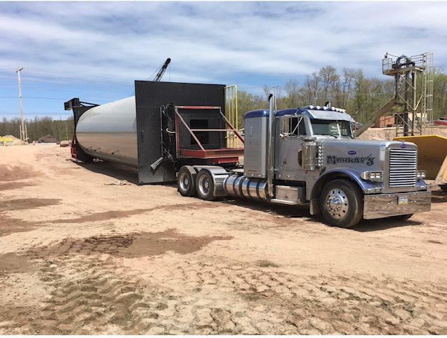 tow truck on the road in summer hauling materials