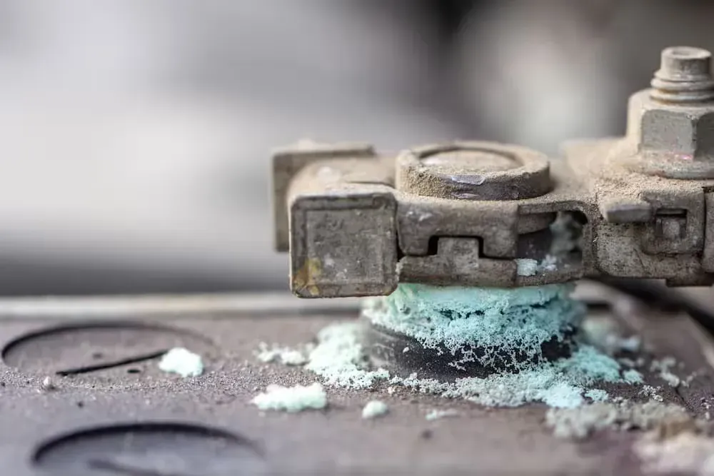 A close up of a battery terminal with a lot of chemicals on it.