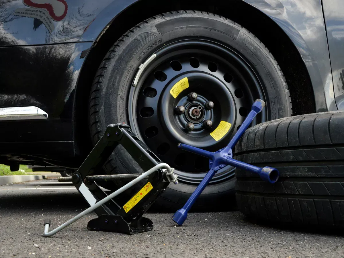 A car with a spare tire and a jack. A car with a spare tire and a jack.