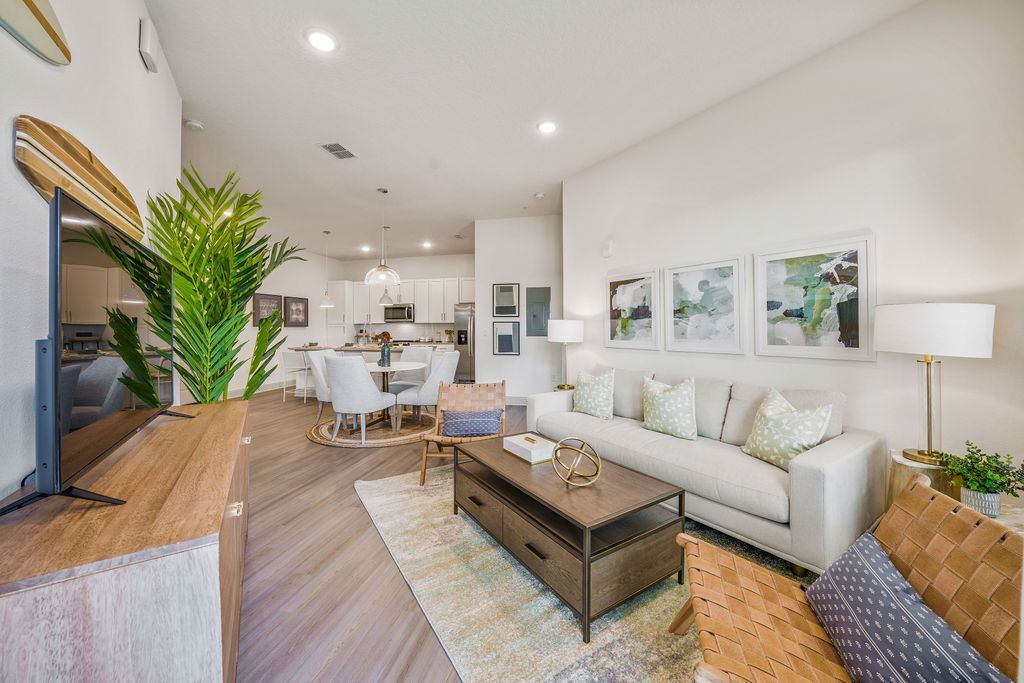 A living room with a couch , coffee table , and television.