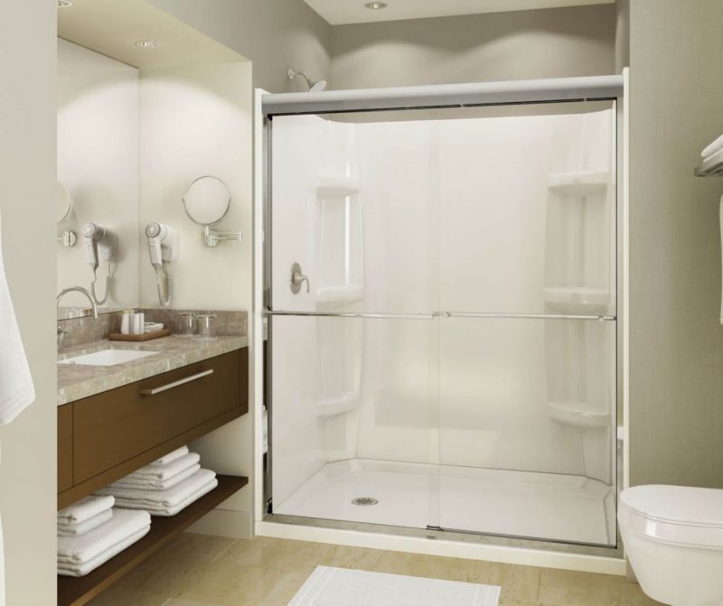A bathroom with a sliding glass shower door