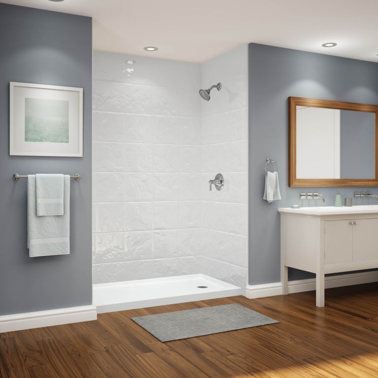 A bathroom with a walk in shower and a sink