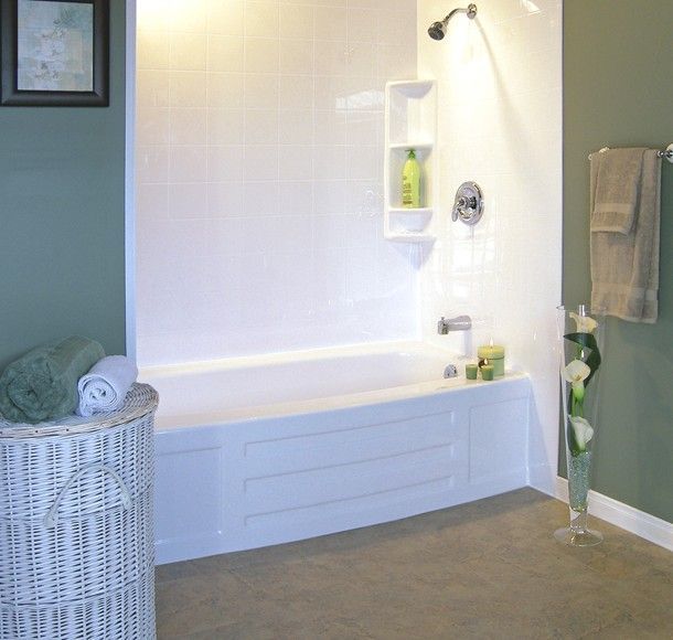 A bathroom with a bathtub and a laundry basket