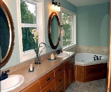 A bathroom with two sinks and a jacuzzi tub.