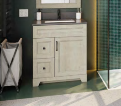 A bathroom with a sink , mirror , and laundry basket.
