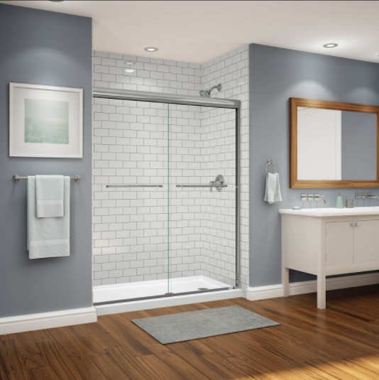 A bathroom with a sliding glass shower door