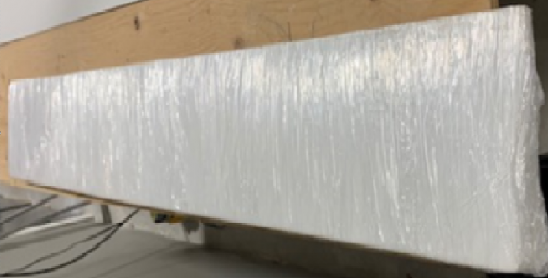 A piece of white plastic is sitting on top of a wooden table.