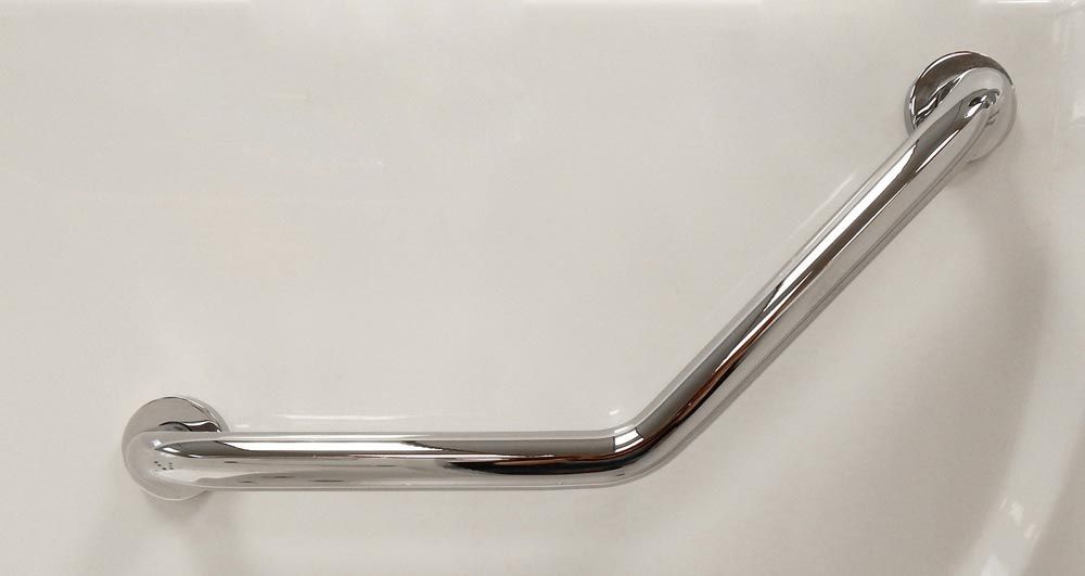 A stainless steel hand rail is attached to a white wall.