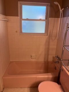 A bathtub is sitting in a bathroom under construction.