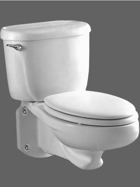 A white toilet is sitting on a gray surface