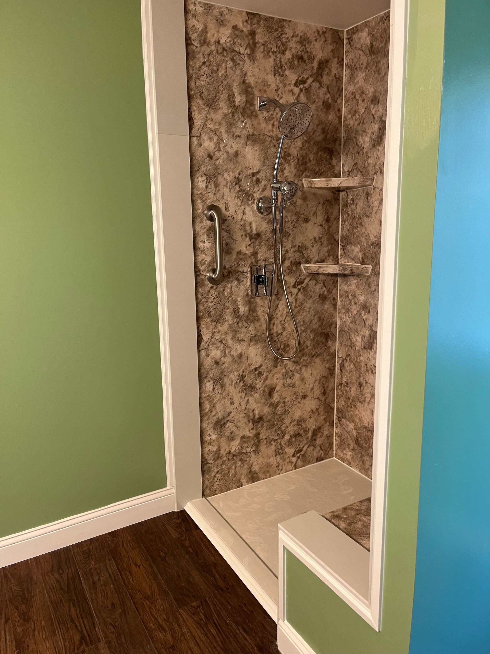 A bathroom with a tub , toilet and shower.