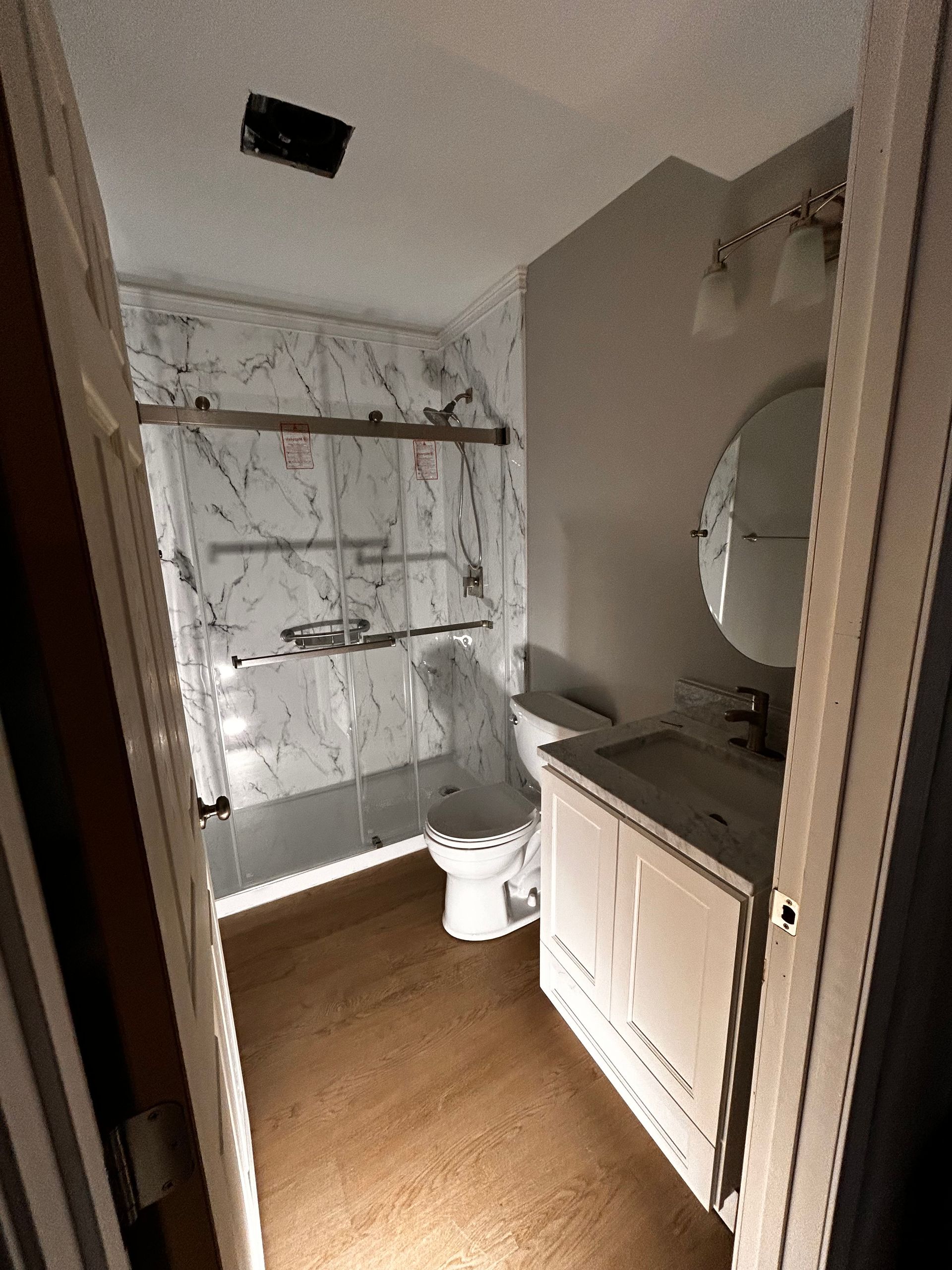 A bathroom with a tub , toilet and shower.