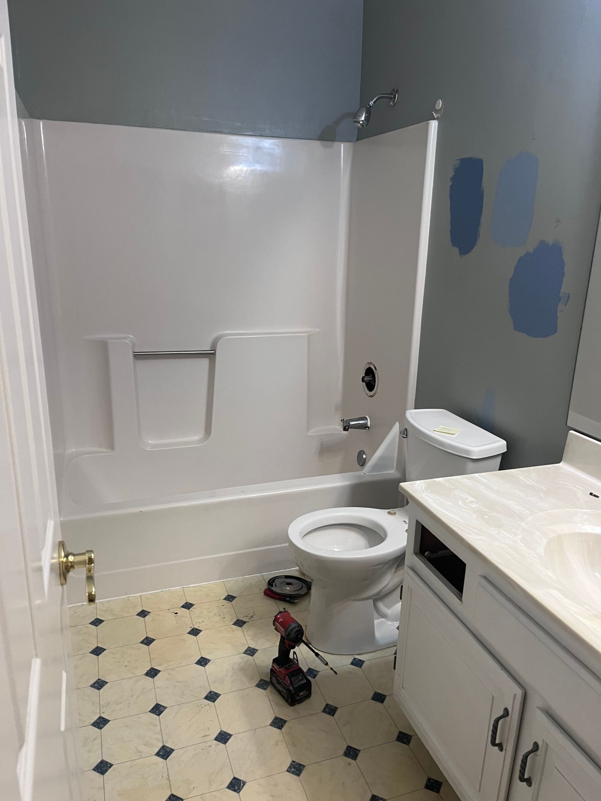 A bathtub is sitting in a bathroom under construction.