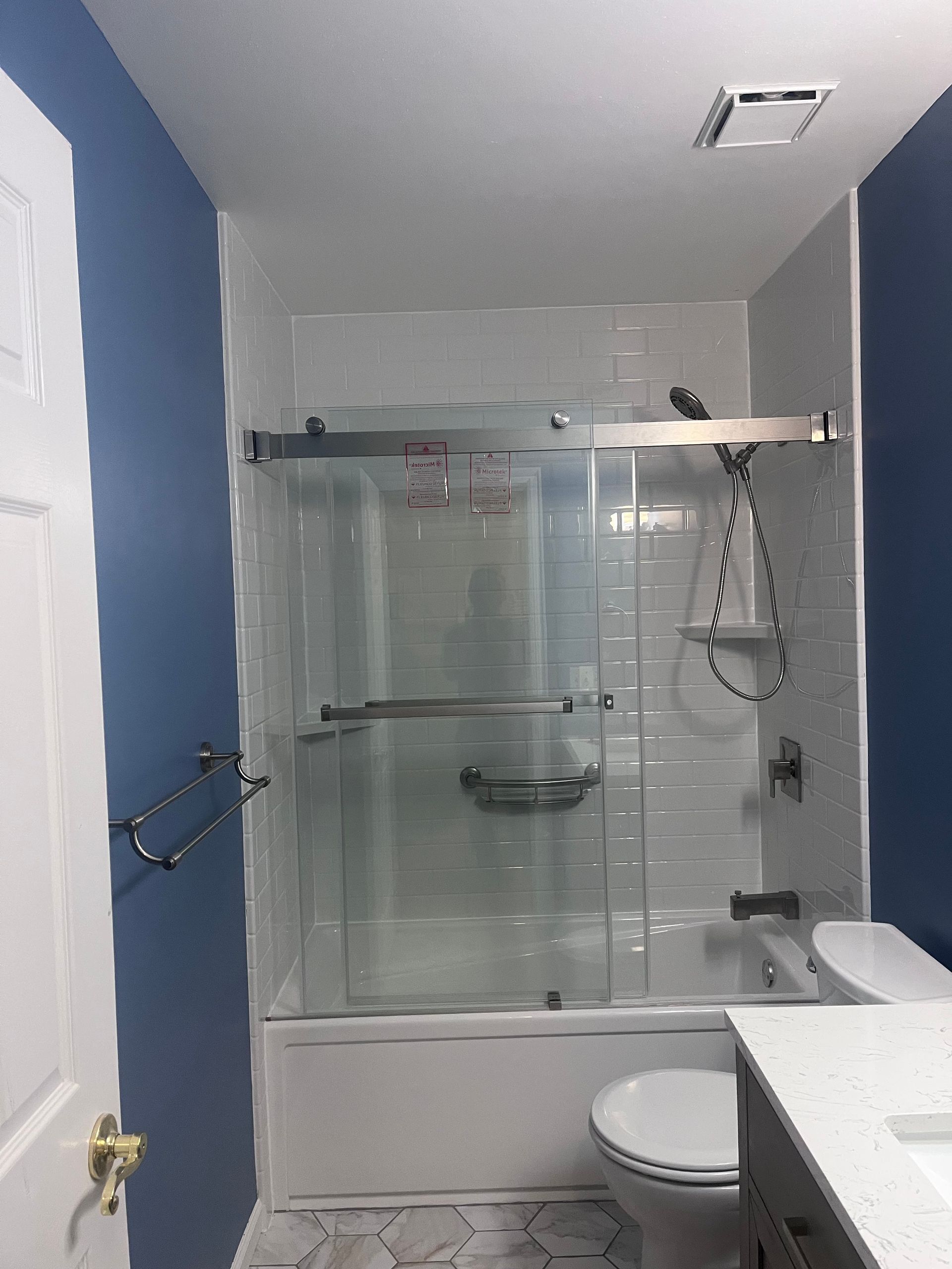 A bathroom with a tub , toilet and shower.