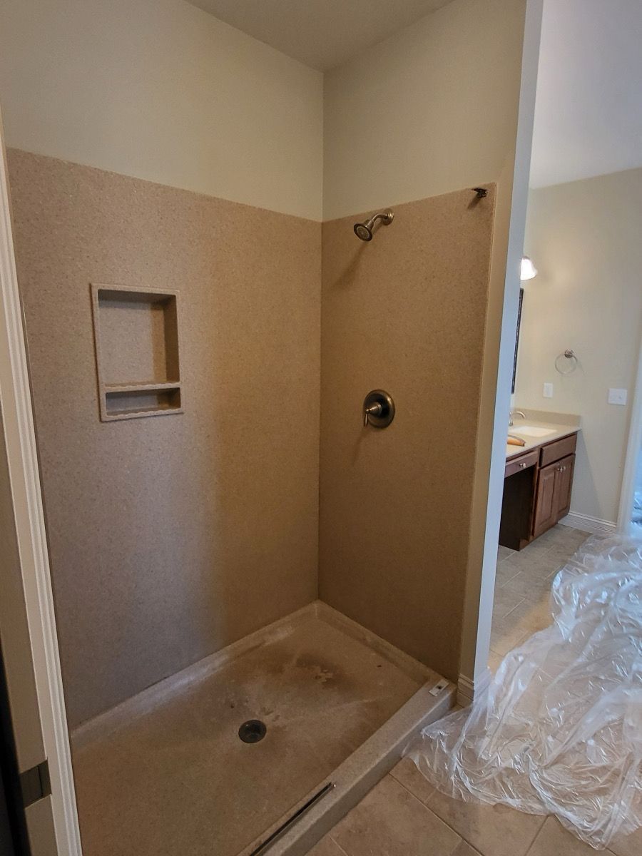 A bathroom with a toilet , tub and mirror.