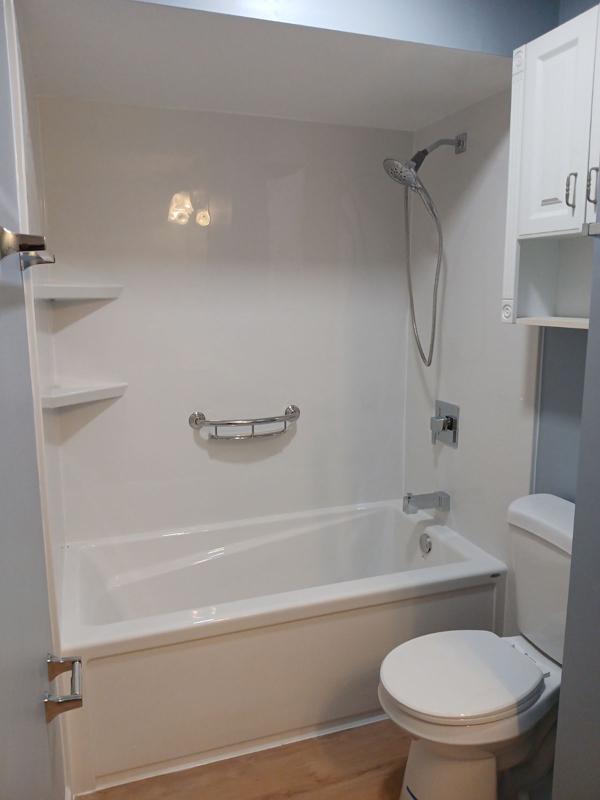 A bathroom with a walk in shower and a toilet.