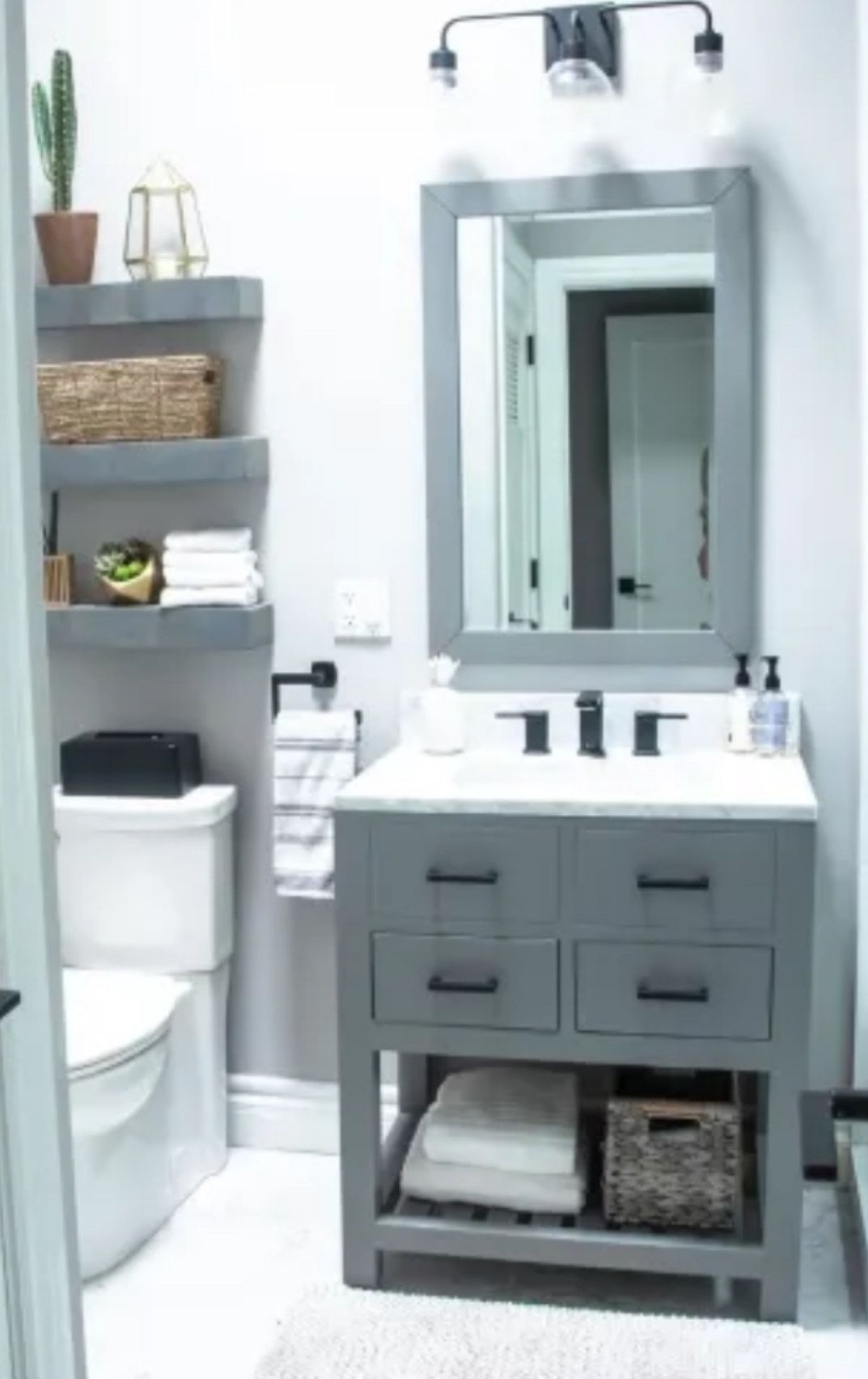A bathroom with a toilet a sink and a mirror