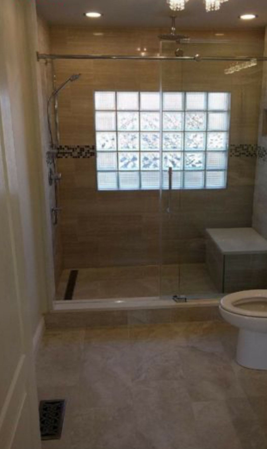A bathroom with a walk in shower and a toilet.