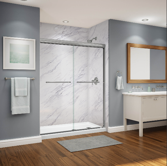 A bathroom with a sliding glass shower door