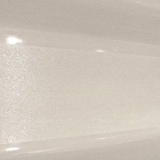 A close up of a white tile with a shiny finish.
