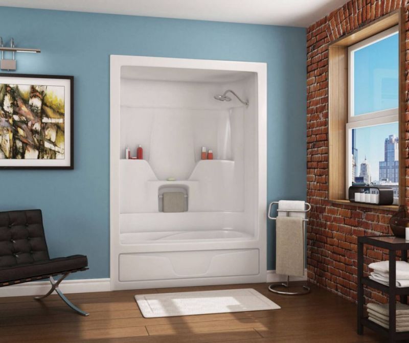A bathroom with a bathtub and a brick wall.