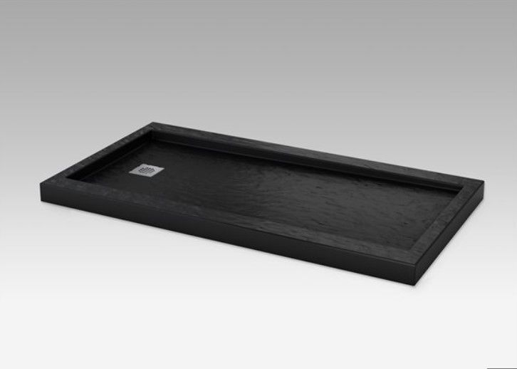 A black tray is sitting on a white surface.