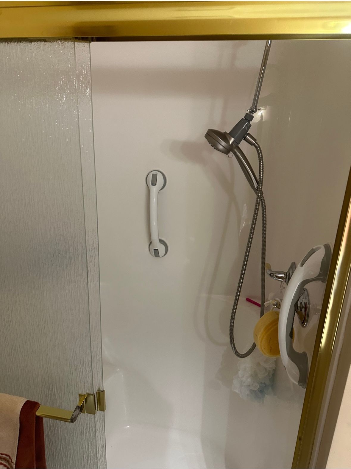 A bathroom with a toilet , tub and mirror.
