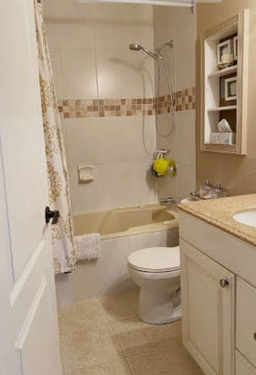 A bathroom with a toilet , sink , tub and shower.