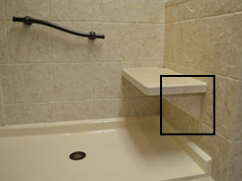 A shower with a shelf on the side of it