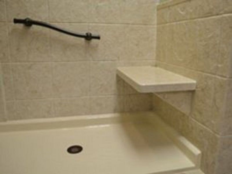 A bathroom with a walk in shower and a shelf.
