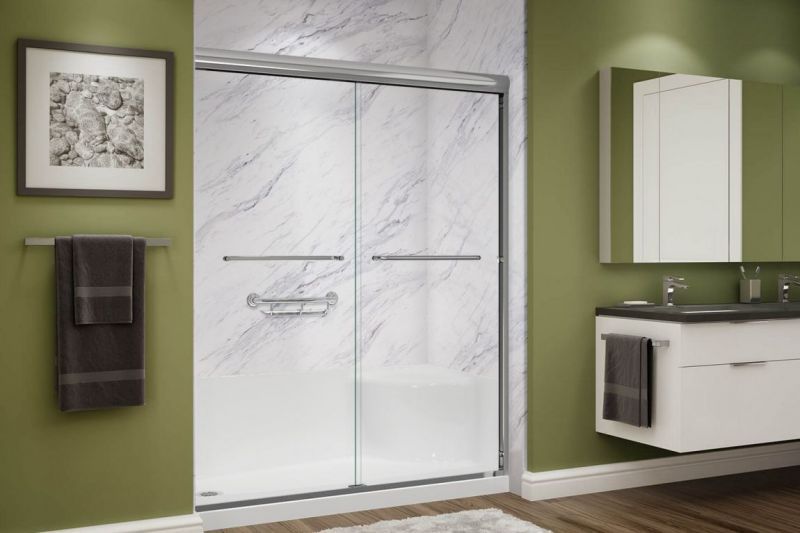 A bathroom with a sliding glass shower door and a sink.