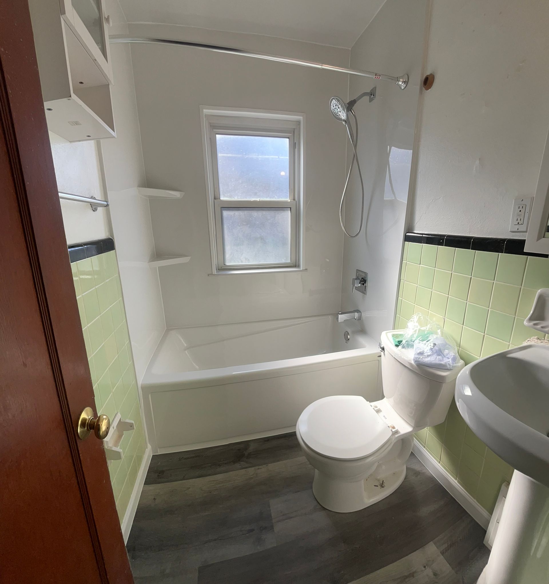 A bathroom with a toilet , sink and bathtub