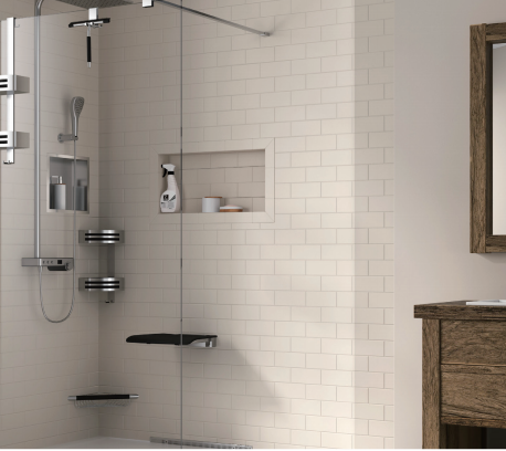 A bathroom with a walk in shower and a sink