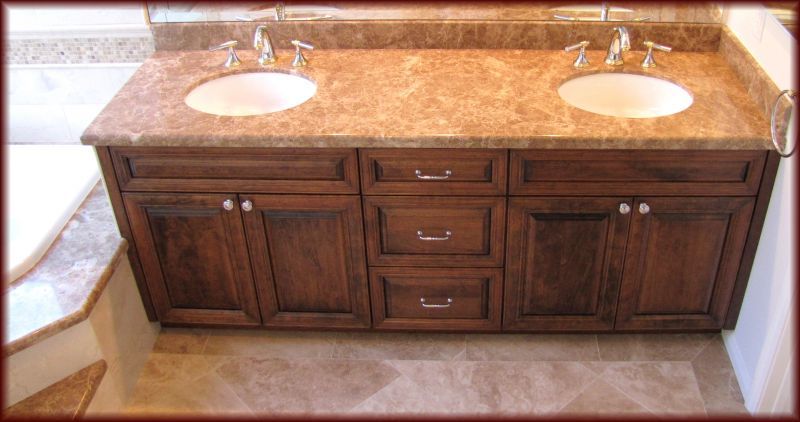 A bathroom vanity with two sinks and a mirror