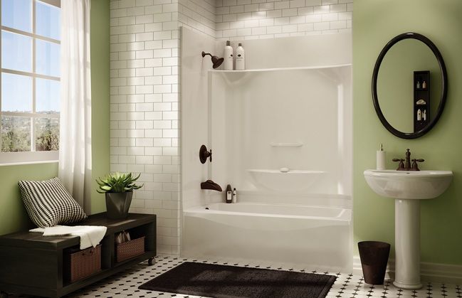 A bathroom with a tub , sink , mirror and window.