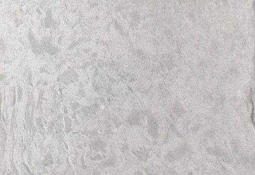 A close up of a white granite counter top.