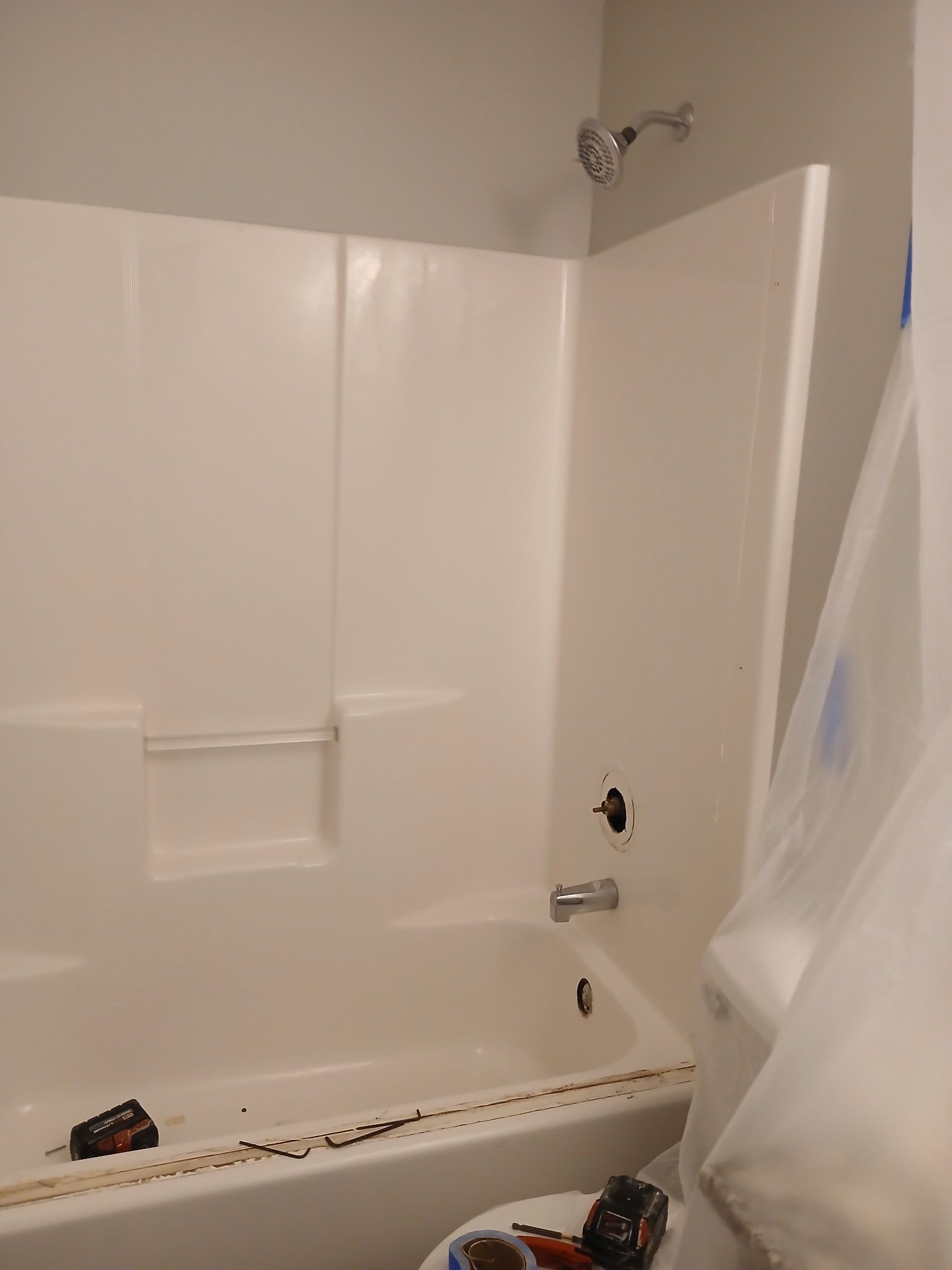 A bathroom with a bathtub and shower being remodeled