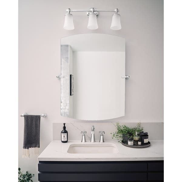 A bathroom with a sink and a mirror above it