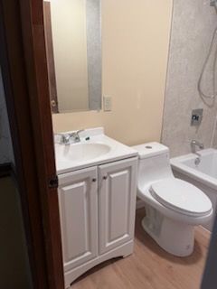 A bathroom with a tub , toilet and shower.